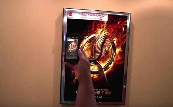 a person scans a hunger games movie poster for more information with the AMC theater app