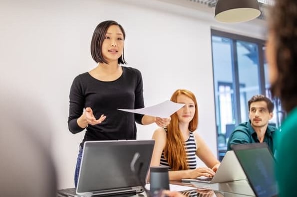 Woman presents her advertorial campaign idea in a marketing meeting