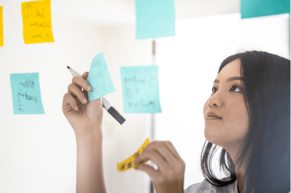 SEO & PPC manager reviewing the digital marketing strategy on a whiteboard