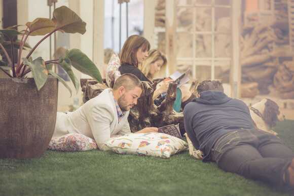 Stokpic image of a group of people reading magazines outside