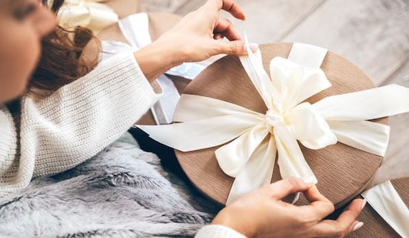 Consumer opens up gift during holiday season
