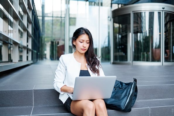 Woman studying Java ArrayLists outside her office building.