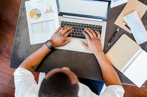 Marketer looking at web analytics on a laptop