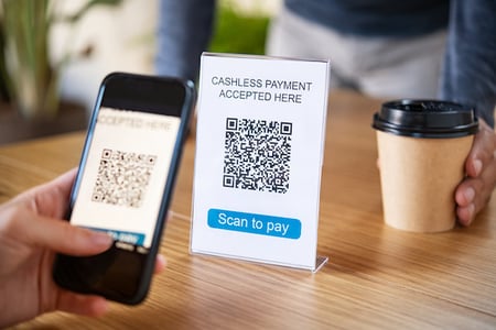 Coffee shop customers use QR code for cashless payment