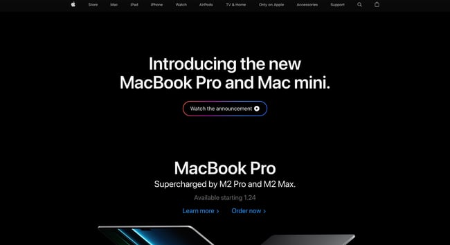 web design challenges: Image shows apple homepage which features text that reads "Introducing the new macbook pro and mac mini" and underneath is a colorful button which reads "watch the announcement" 