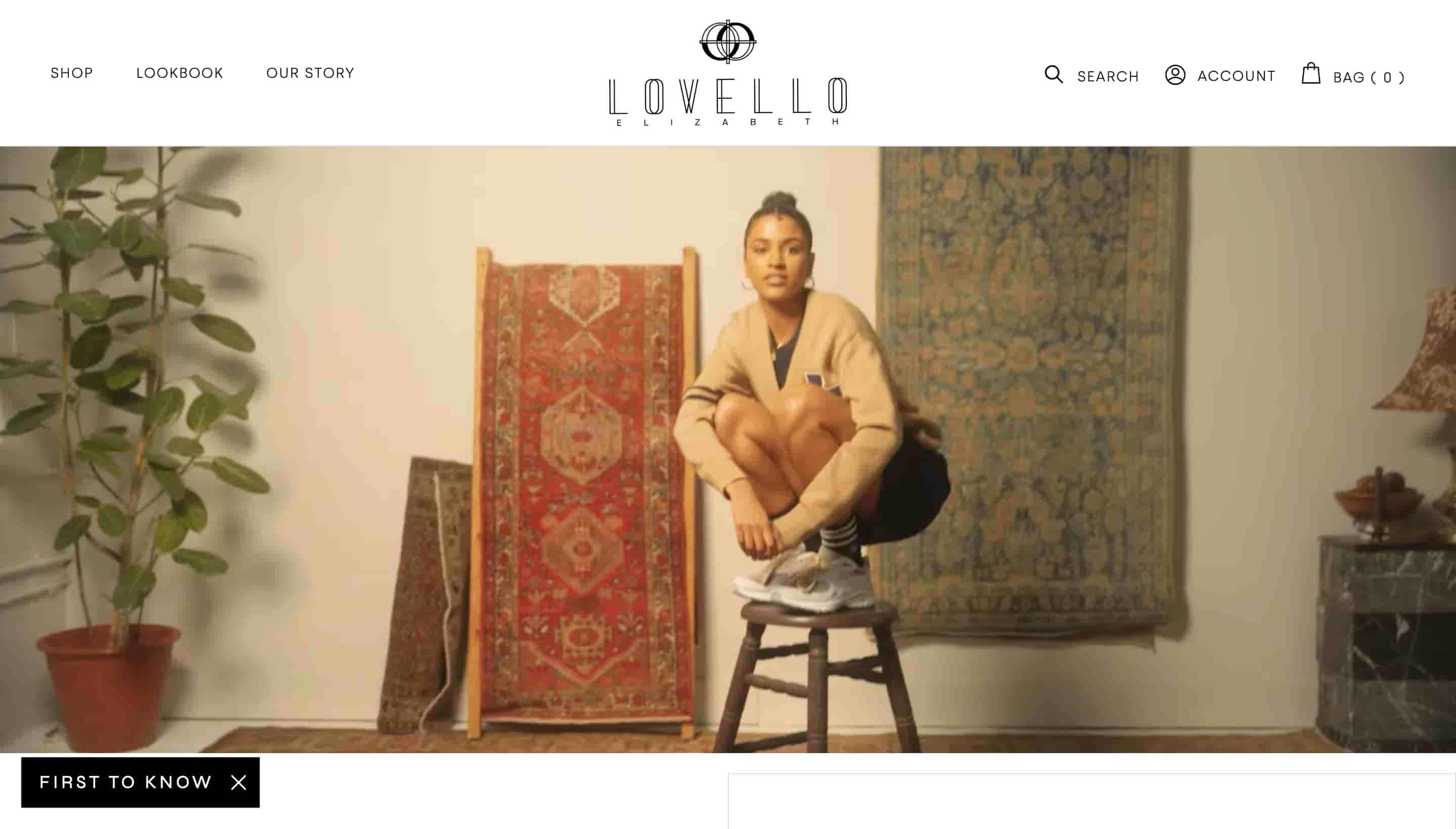 fashion website design lovello elizabeth shows person squatting on a stool with rugs in the background 