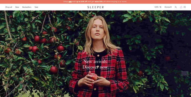 fashion website design homepage: sleeper shows person with an apple in their hand. 