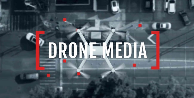 VIDEOGRAPHER THEME WORDPRESS: DRONE MEDIA HOMEPAGE SHOWS A VIEW OF A STREET FROM A DRONE 