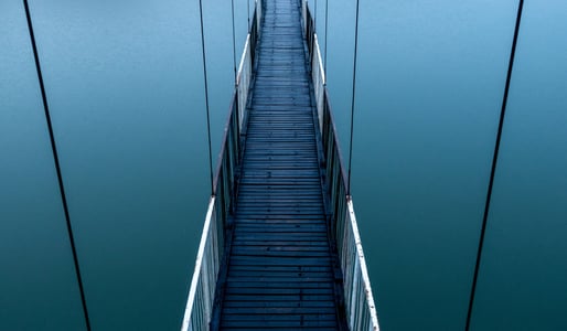 Suspended blue bridge across a blue background