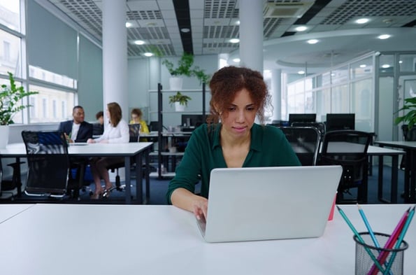 Woman studying what Python is in a shared office space