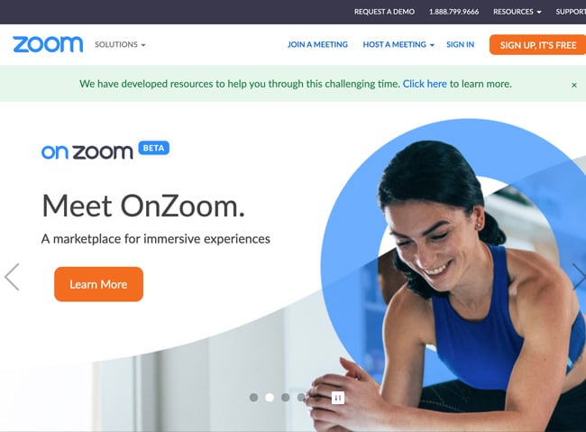 Zoom Website homepage that shows a woman finishing a workout and text that reads meet on zoom a marketplace for immersive expereinces