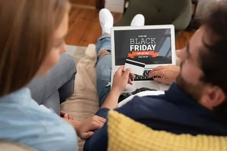 consumers look at Black Friday Ads