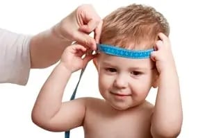 image of child with tape measure around head signifying measuring blog kpis to track