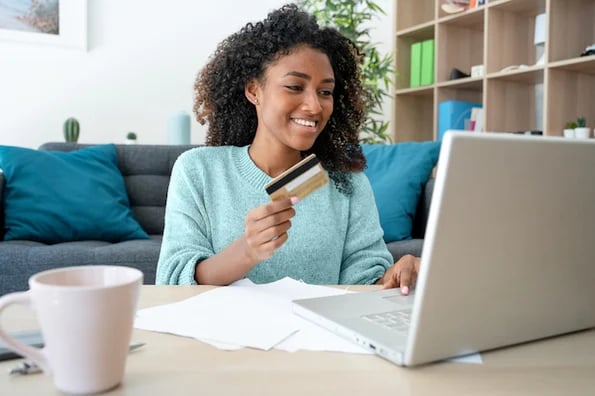 buyer persona myths: image shows woman on laptop holding credit card