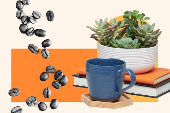 a coffee cup with coffee beans and a plant sitting on top of books