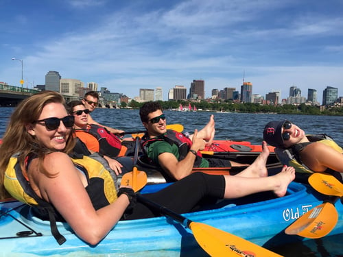 Five coworkers kayaking on a company outing