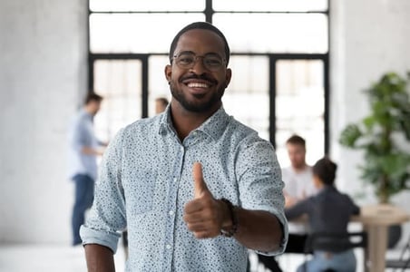 business owner giving thumbs up after learning about consumer psychology