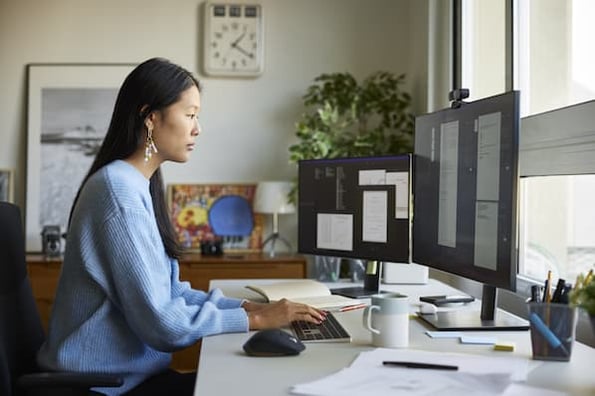 Woman at work looking at corporate website examples for inspiration