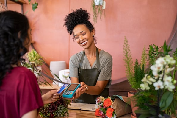 Small business owner accepting credit card payment