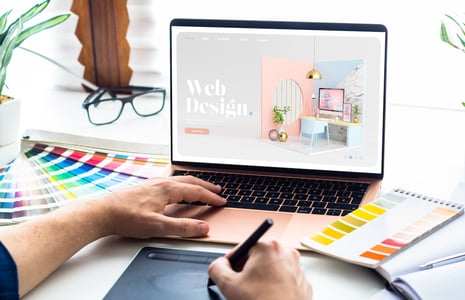 web designer looking at famous web design style guide examples to create their own