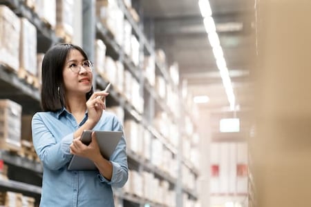 woman of color entrepreneur manages inventory for company