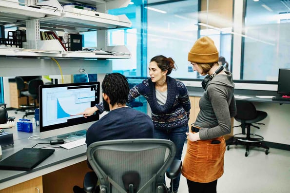 People looking at google analytics segmentation data in a lab
