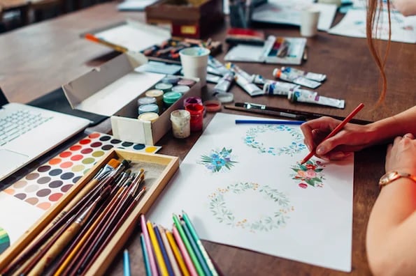 habits that boost creativity: image shows person with colored pencils creating art
