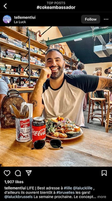 Micro-influencer Telle Mentlui takes a picture next to Coca-Cola products