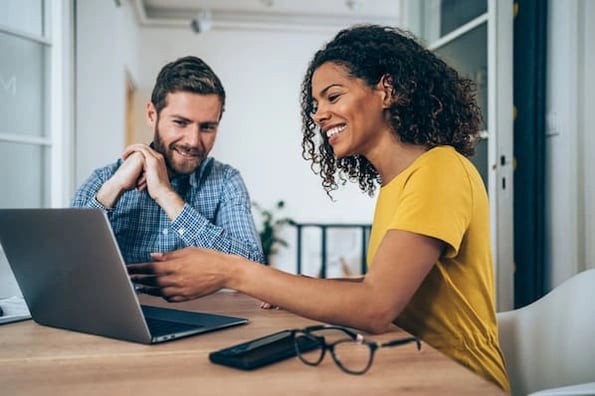 two people reviewing sales reports templates