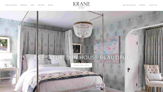 interior design websites: krane home shows a large bed and text overlay about previous accolades 