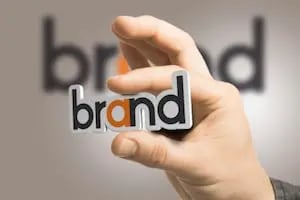hand holding the word 'brand'