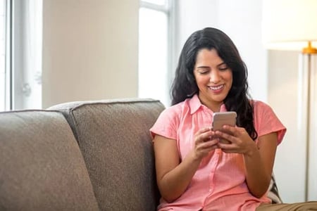 a woman receives a text from a brand's SMS marketing campaign.