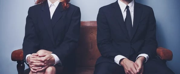 two people in suits waiting for job interview