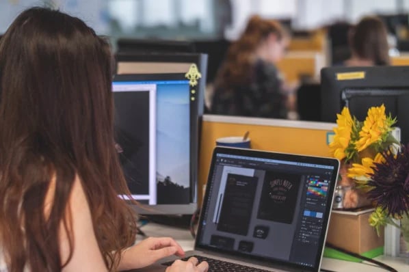 woman at laptop creating logo design