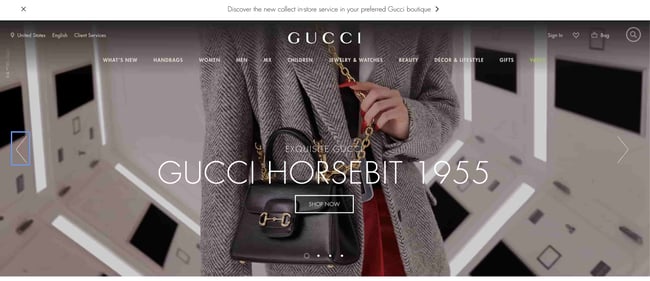 Luxury websites: Gucci. The site shows a model wearing one of the brand's bags.