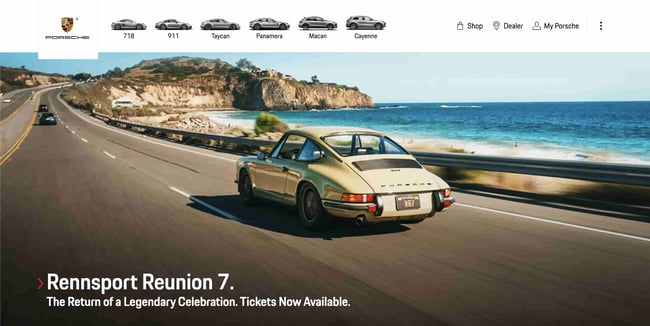 Luxury websites: Porsche. Image shows a Porsche vehicle cruising down a highway coast.