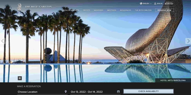 Luxury websites: Ritz Carlton. Website shows a scene with palm trees that was taken at one of the company's hotels in Barcelona.