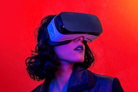 A woman bathed in purple and blue light enters the metaverse via VR headset. A red background is behind her.