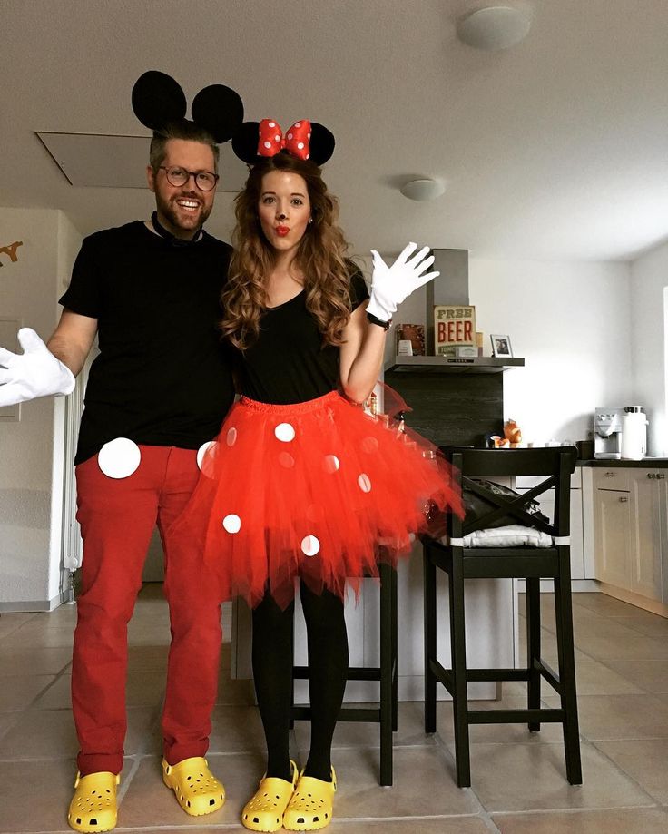 Couple dressed as Mickey and Minnie mouse for office Halloween party
