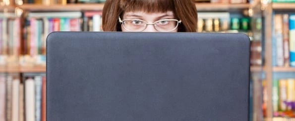 woman reading off-site content on laptop