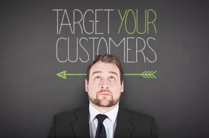 persona-centric website experience: photo shows man in front of text that reads 'target your customers'