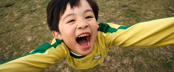 psychology of excitement: image shows young child yelling in excitement