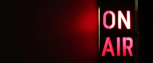 on air sign lit up in red