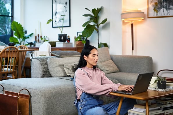 Resignation Letter Example: woman typing on laptop at home