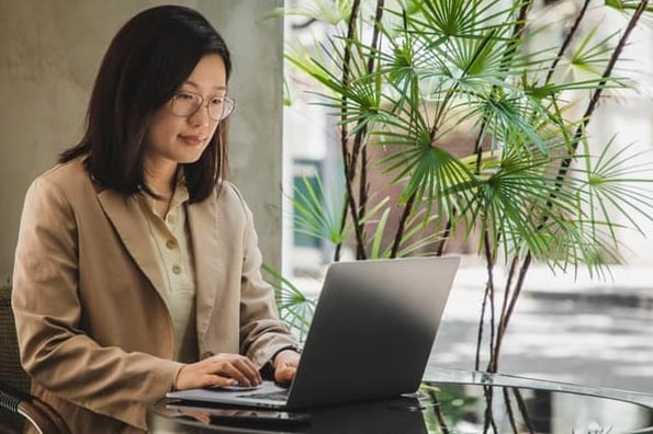 Woman uses a Google Docs resume template from her laptop