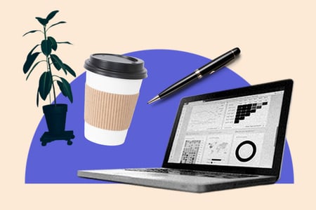 sales analyst interview questions: sales analyst desk with a laptop, coffee cup, plant, and pen