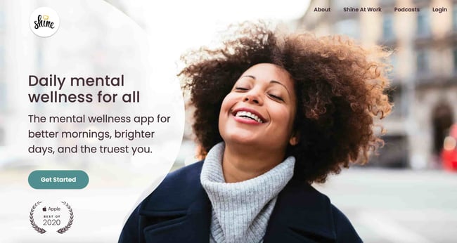 simple website examples: the shine app. image shows a person walking through the street smiling. 