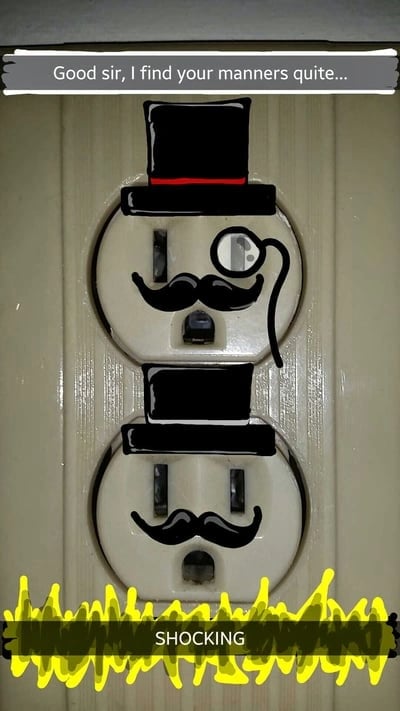 Funny Snapchat drawing of electrical outlets with hats and mustaches with the caption "Shocking"