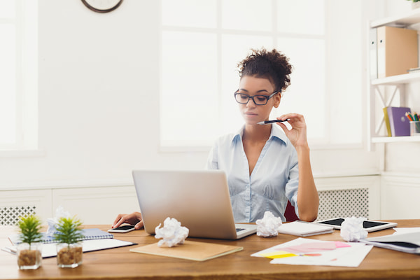 Woman starting a sole proprietorship and looking at the forms she has to fill out