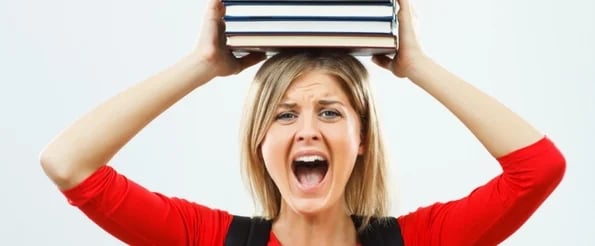 most successful dropouts: image shows woman yelling with stack of books on head